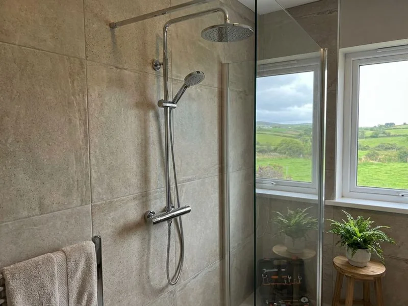 Completed thermostatic mixer shower installation with chrome fittings in a renovated en-suite bathroom in County Sligo